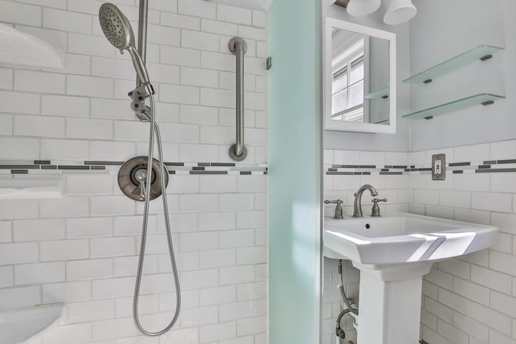 22 Withington Lane Harvard, MA 01451 - Photo 22 of 29 a bathroom with a sink a mirror and shower