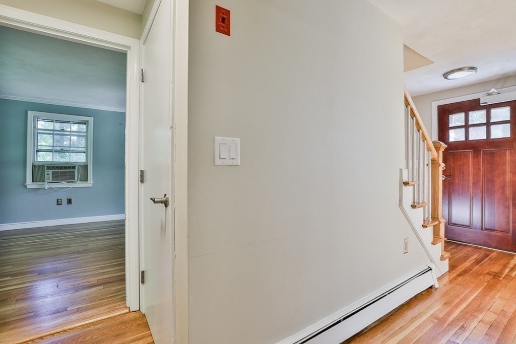 22 Withington Lane Harvard, MA 01451 - Photo 9 of 29 a view of a hallway with wooden floor and staircase