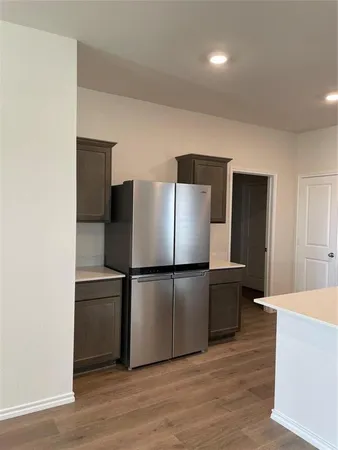 a kitchen with stainless steel appliances a refrigerator and a microwave