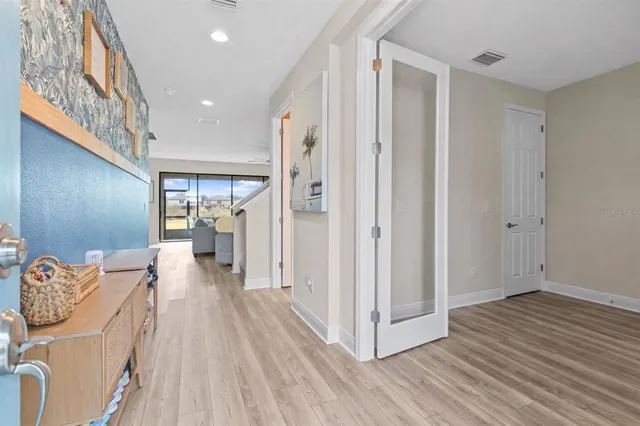 a view of a hallway view with wooden floor and staircase