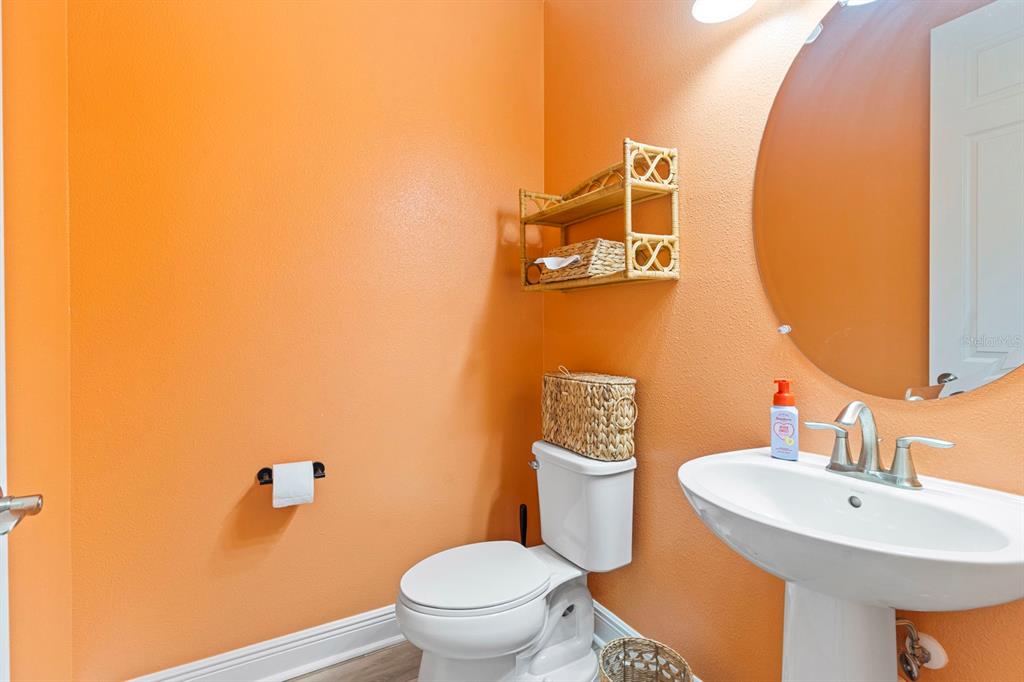 14661 Horse Trot Road Lithia, FL 33547 - Photo 18 of 46 a bathroom with a toilet sink and mirror
