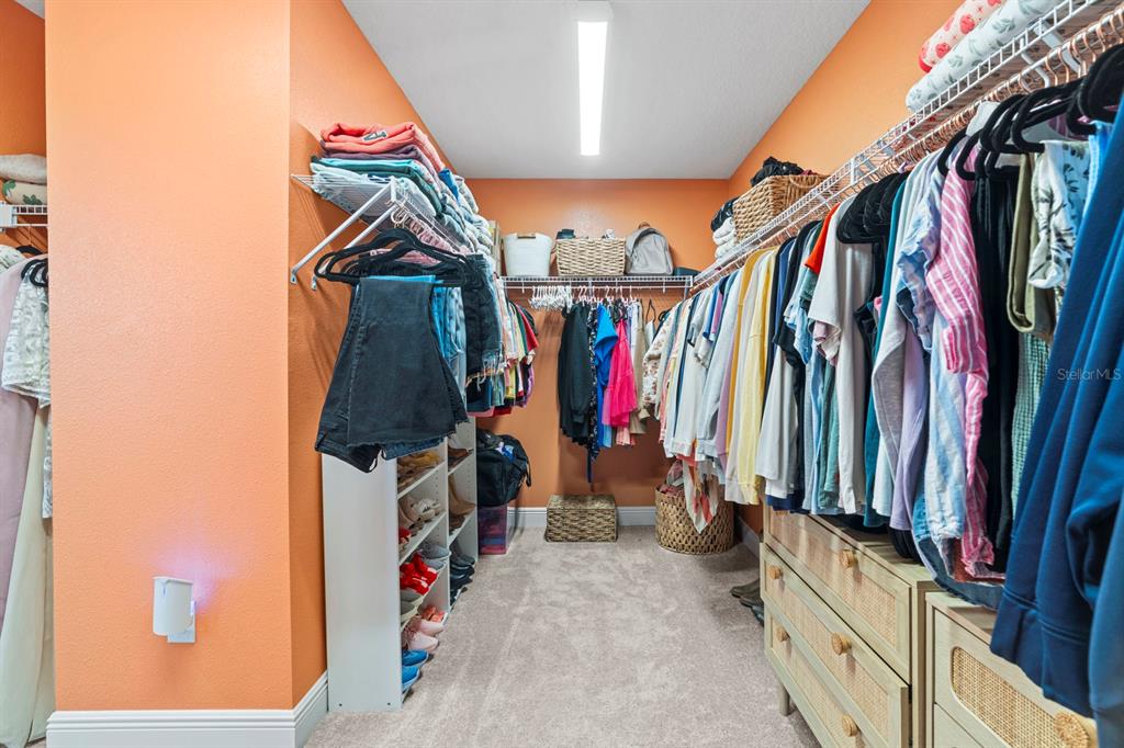 14661 Horse Trot Road Lithia, FL 33547 - Photo 26 of 46 a view of walk in closet with clothes and shoes