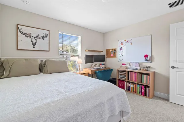 a bed room with a bed and a television