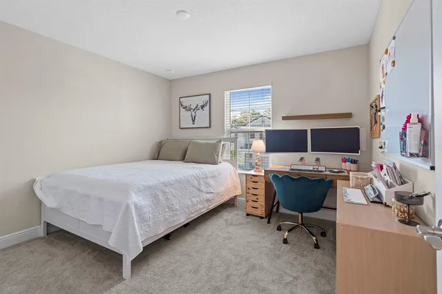 a bed room with a bed and a desk