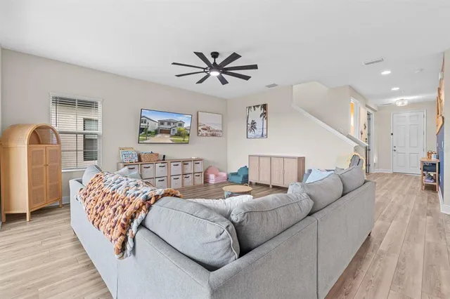 a living room with furniture and a chandelier