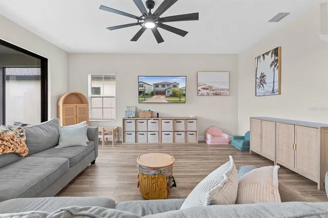 a living room with furniture and wooden floor