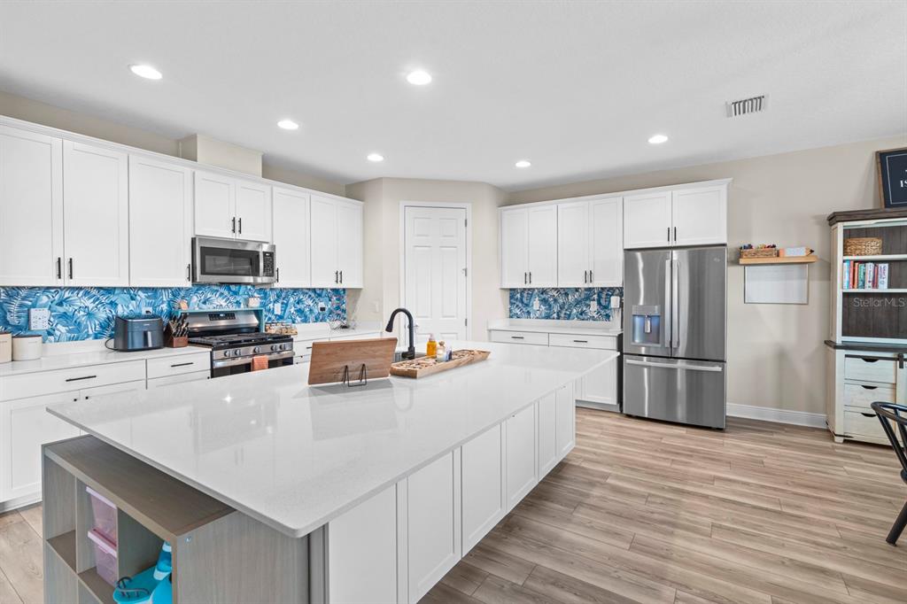 14661 Horse Trot Road Lithia, FL 33547 - Photo 8 of 46 a kitchen with stainless steel appliances a refrigerator sink and microwave