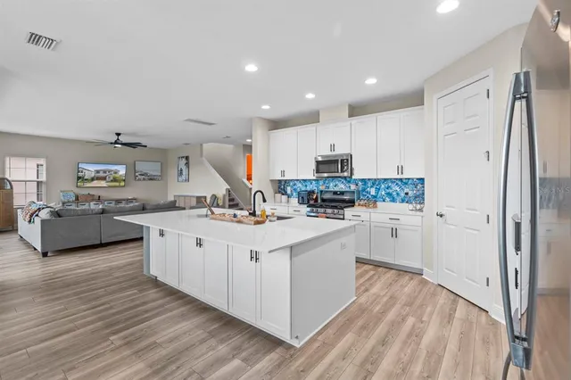 a kitchen with white cabinets and white appliances