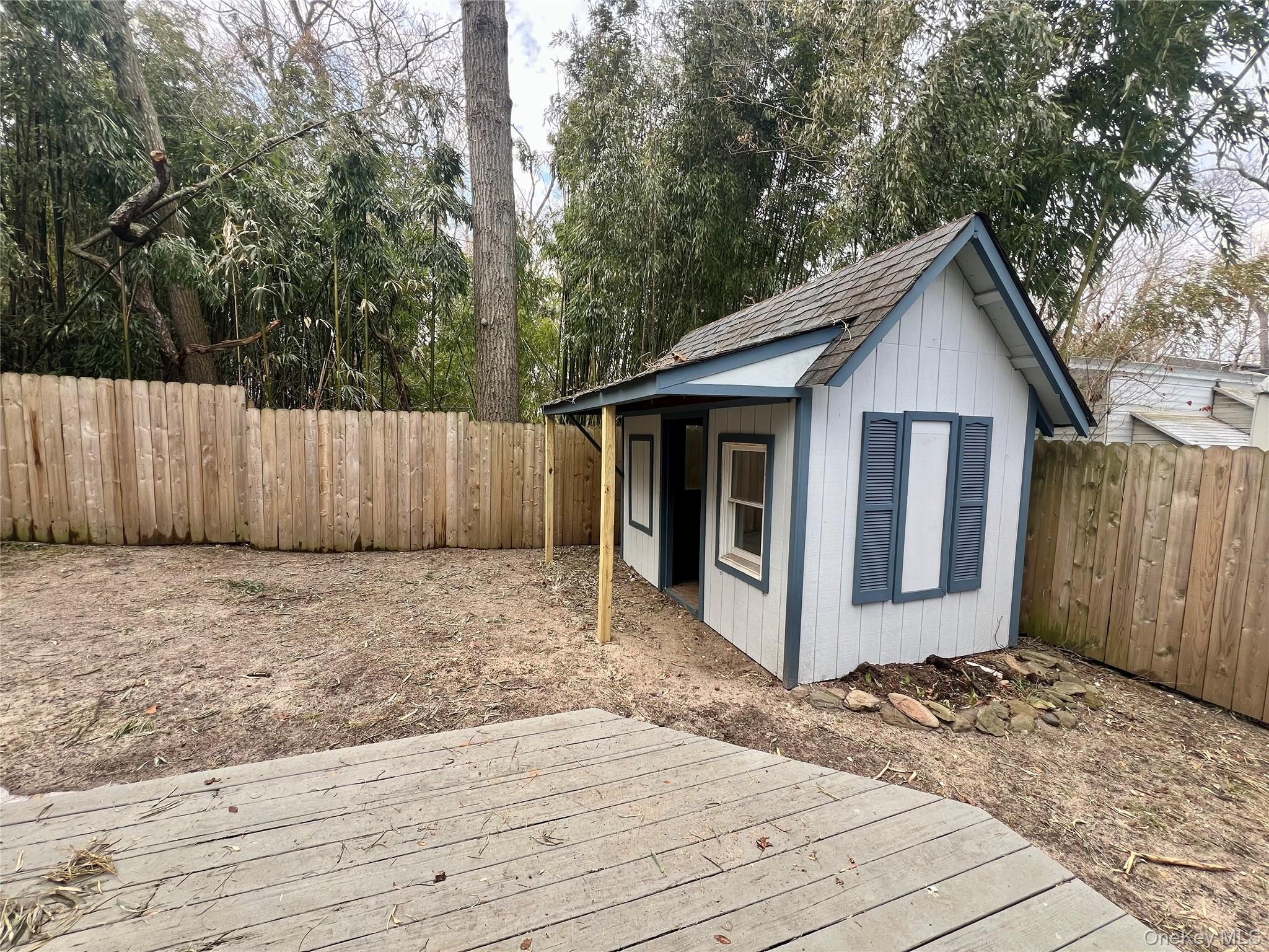 10 Rutland Road Mastic, NY 11950 - Photo 11 of 12 a front view of a house with a garage
