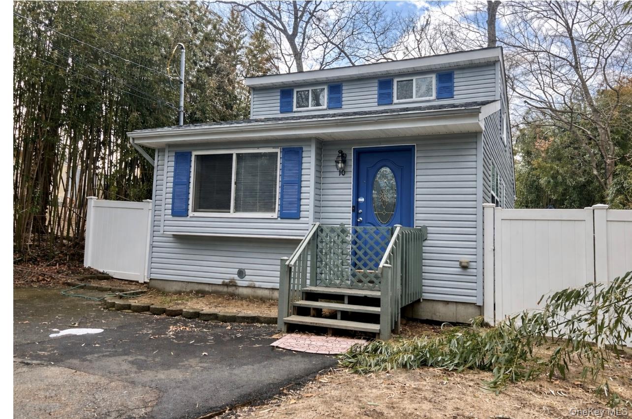 10 Rutland Road Mastic, NY 11950 - Photo 2 of 12 a front view of a house with garden