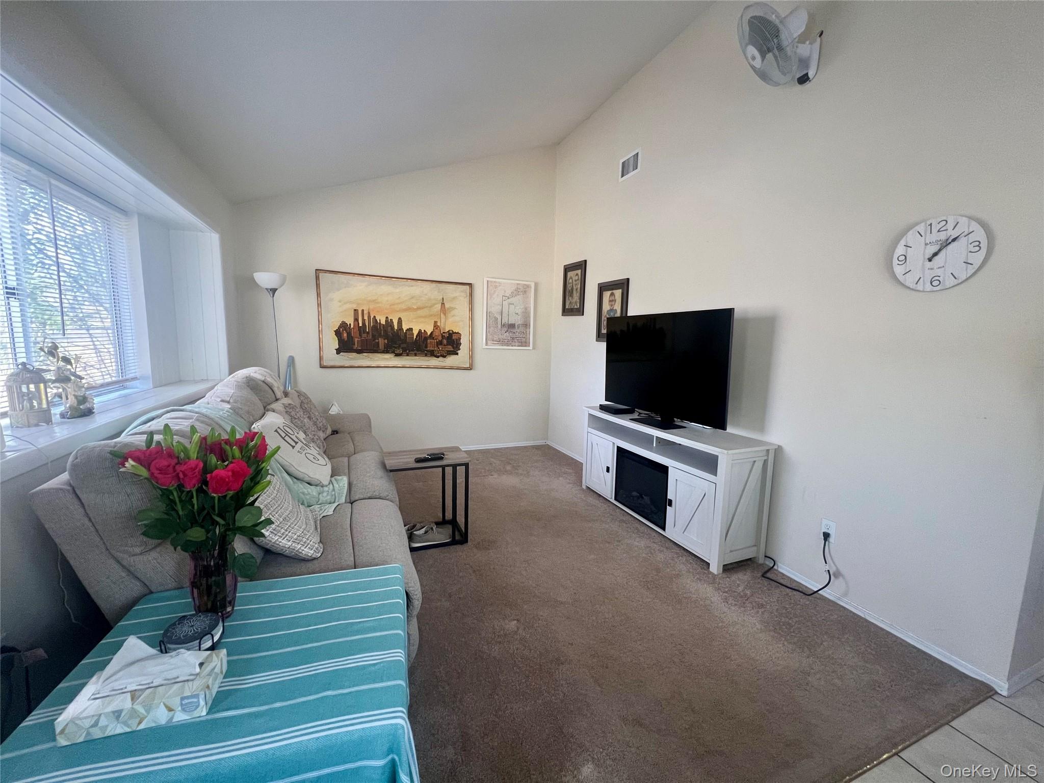 10 Rutland Road Mastic, NY 11950 - Photo 4 of 12 a living room with furniture and a flat screen tv