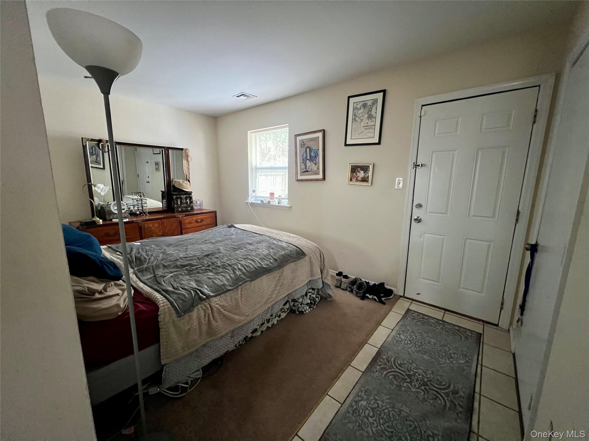 10 Rutland Road Mastic, NY 11950 - Photo 6 of 12 a bedroom with a bed and a chandelier