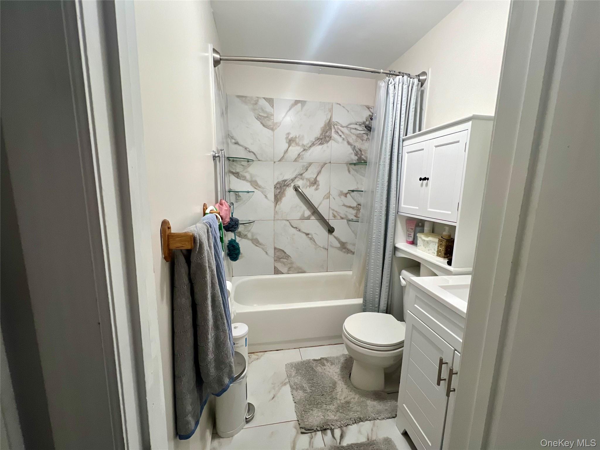 10 Rutland Road Mastic, NY 11950 - Photo 7 of 12 a bathroom with a toilet and a shower
