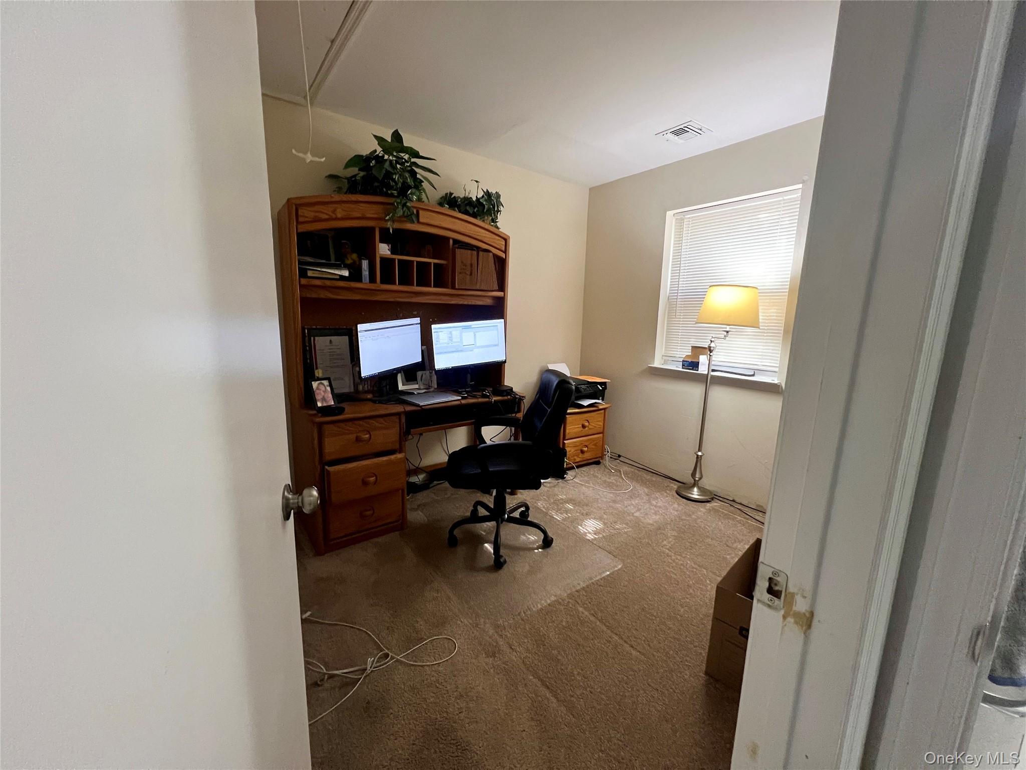 10 Rutland Road Mastic, NY 11950 - Photo 8 of 12 a view of a workspace with furniture and a window
