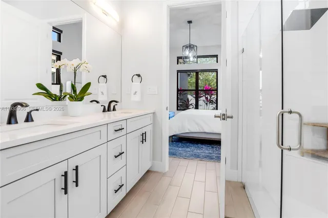 a en suite bathroom with a double vanity sink and shower