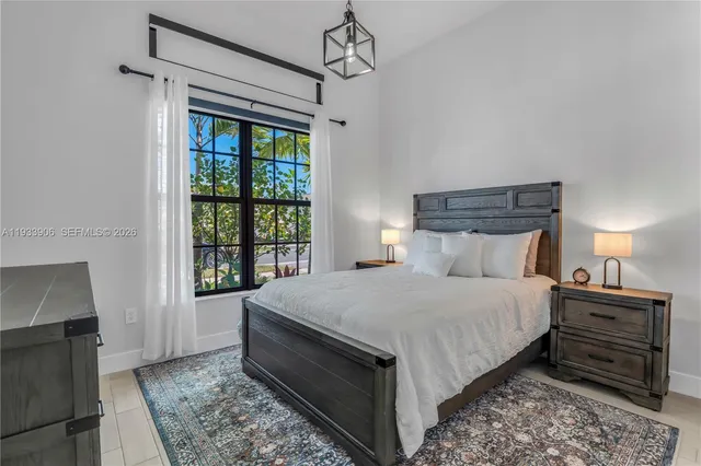 a bedroom with a large bed and a window