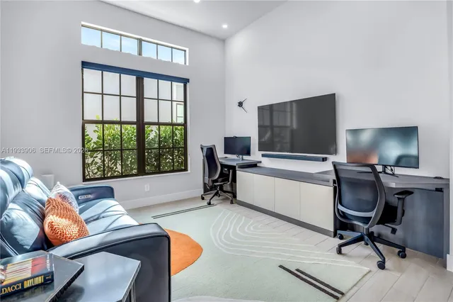 a livingroom with workspace and a window