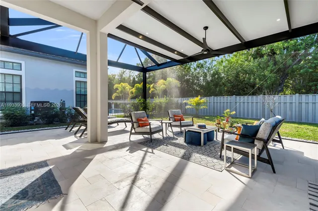 a view of a patio with a dining table and chairs