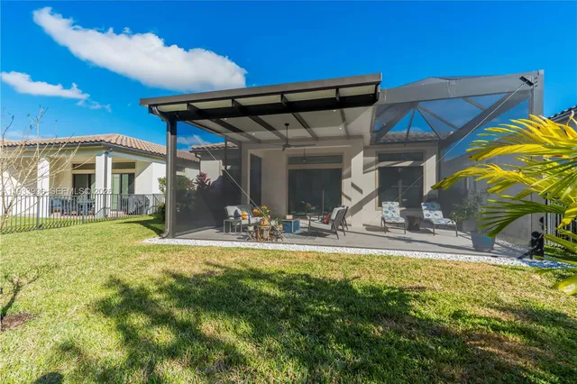 a view of a house with backyard porch and sitting area