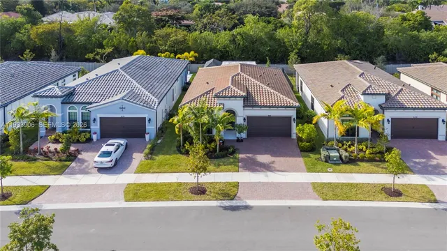 an aerial view of a house with a garden and large trees