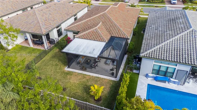 an aerial view of a house with a yard basket ball court and outdoor seating