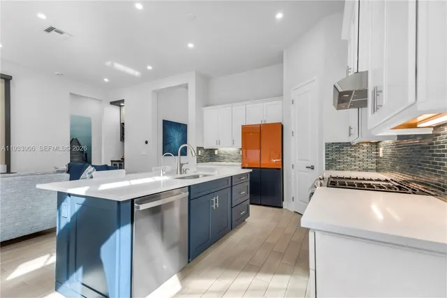 a kitchen with a sink stove and cabinets