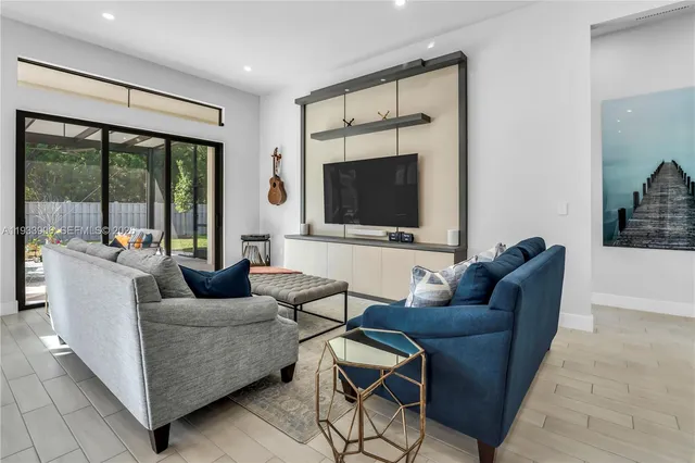 a living room with furniture and a flat screen tv