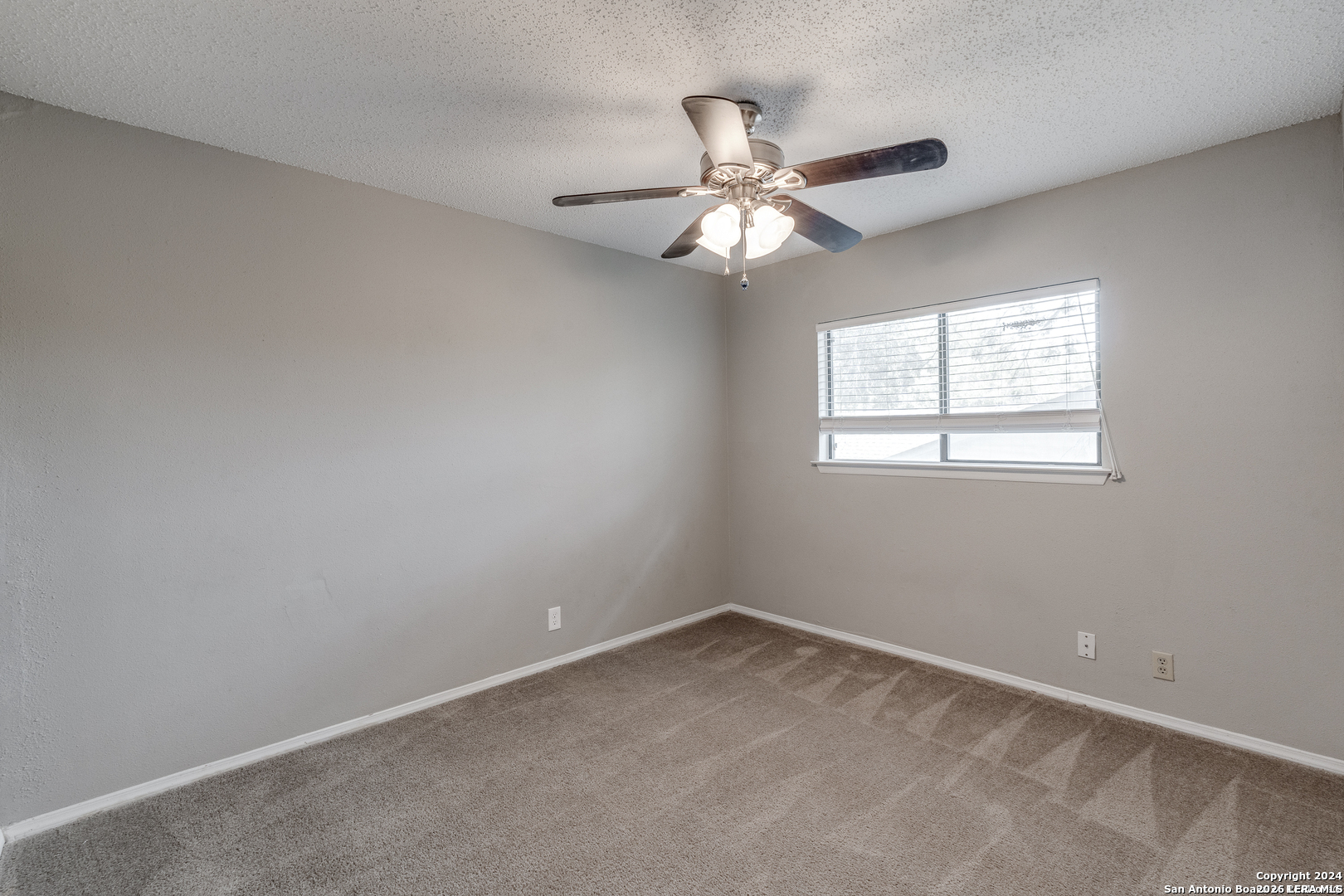 9727 Fortune Ridge Drive Converse, TX 78109 - Photo 11 of 14 an empty room with a window and a fan