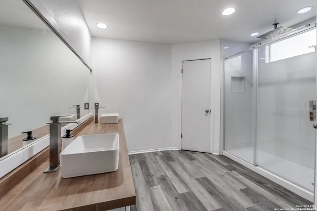 a bathroom with a sink and mirror