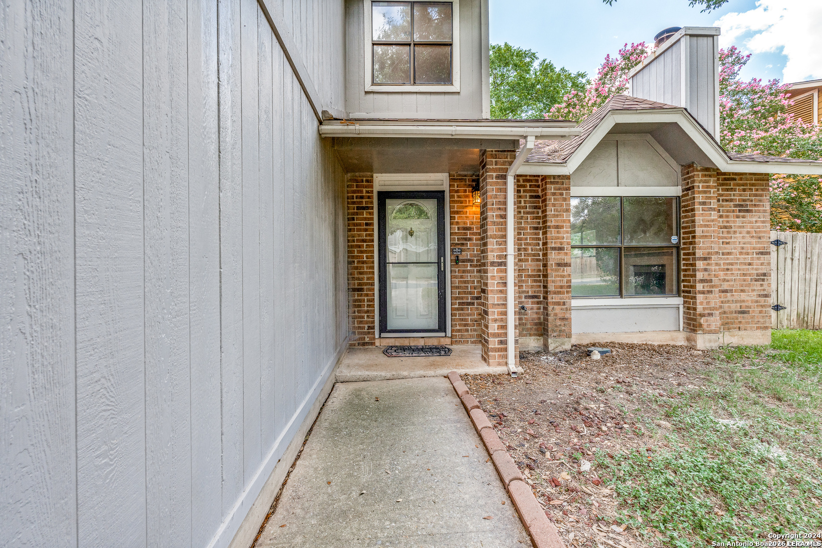9727 Fortune Ridge Drive Converse, TX 78109 - Photo 2 of 14 a view of a brick house with large windows