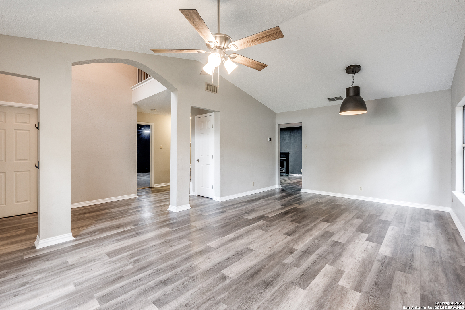 9727 Fortune Ridge Drive Converse, TX 78109 - Photo 3 of 14 a view of an empty room with wooden floor and a ceiling fan