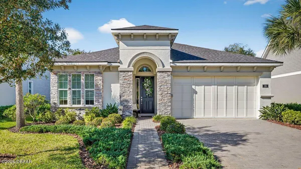 a front view of a house with garden