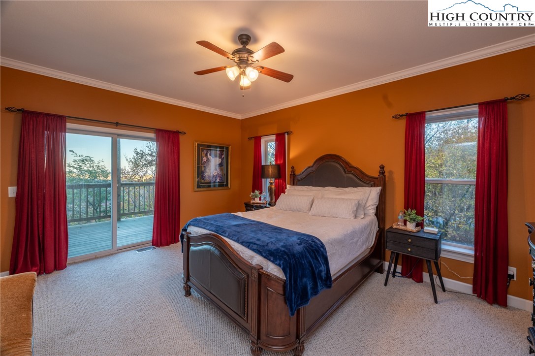 309 Pinnacle Ridge Road Beech Mountain, NC 28604 - Photo 22 of 45 a bedroom with a bed and a chandelier