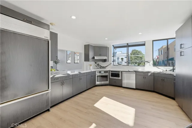a kitchen with a sink and wooden floor