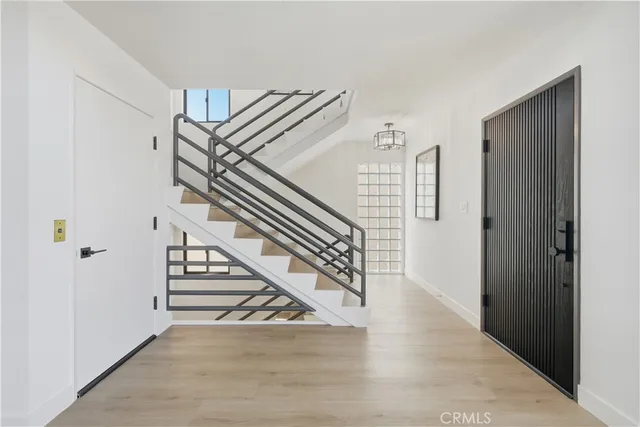 a bathroom with a granite countertop sink a toilet a mirror and shower