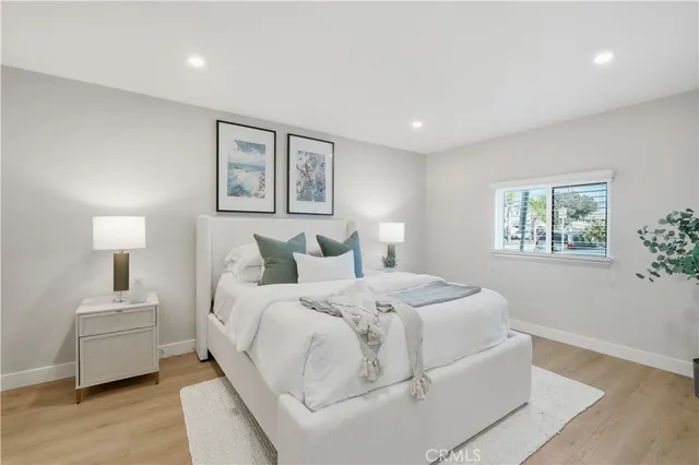 a bedroom with bed and a night stand