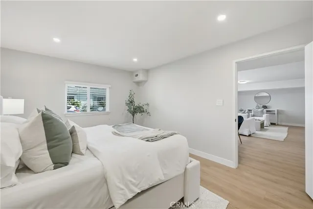 a bedroom with a bed and a large mirror