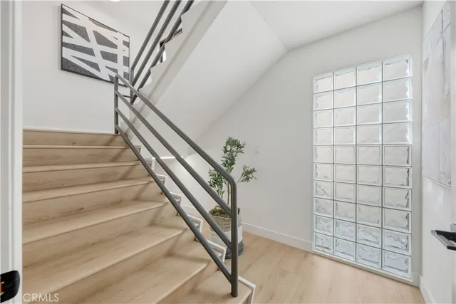 a view of staircase with white walls and a window