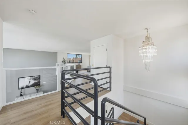 a view of a room with furniture and wooden floor