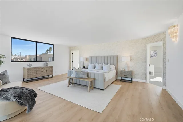 a bed room with a bed and a painting on the wall