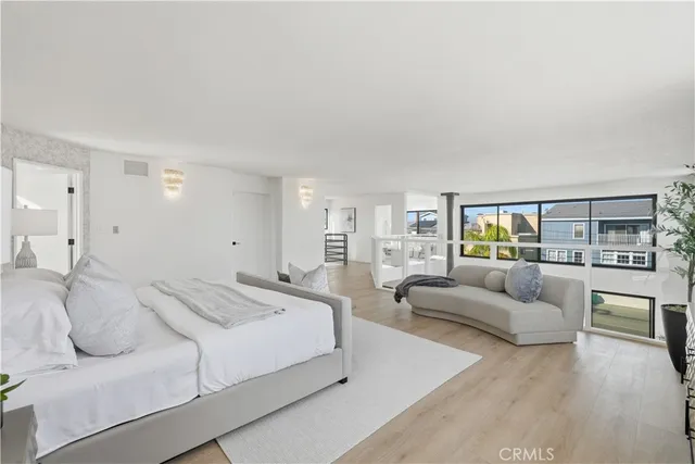 a spacious bedroom with a bed and couch