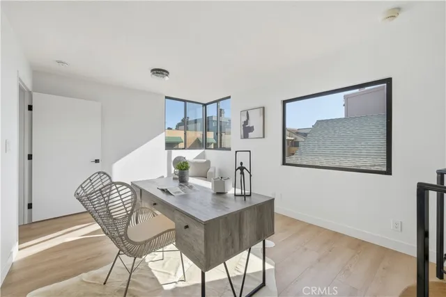 a dining room with furniture and wooden floor