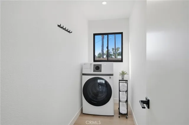 a view of a hallway with washer and dryer