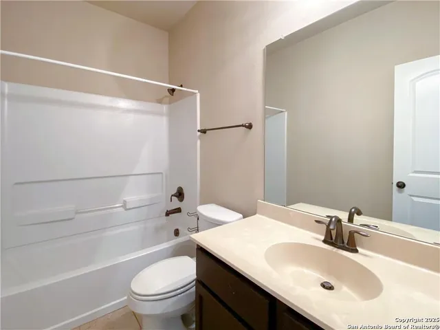 a bathroom with a sink toilet vanity and shower