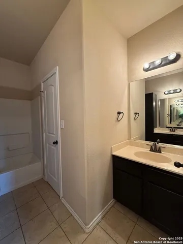 a bathroom with a double vanity sink a mirror and a shower