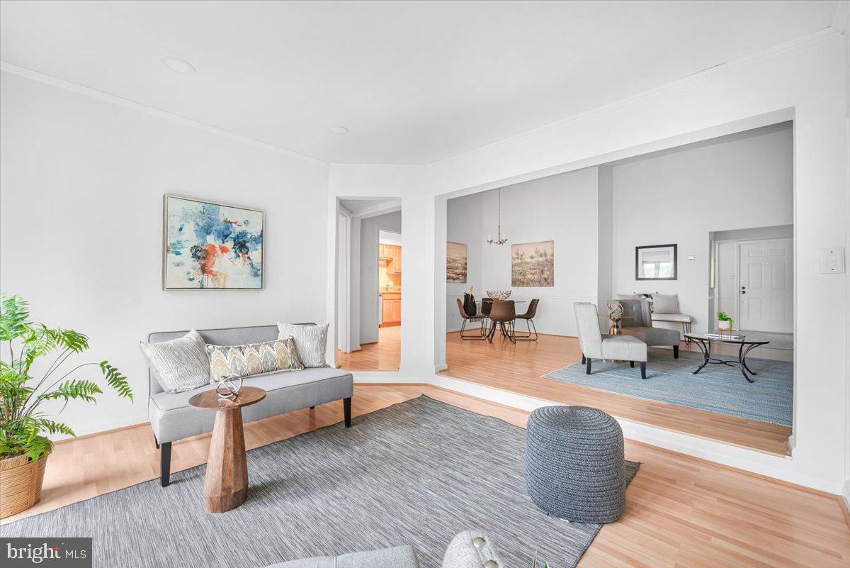 10717 Kings Riding Way, Unit 301 Rockville, MD 20852 - Photo 11 of 22 a living room with furniture and wooden floor