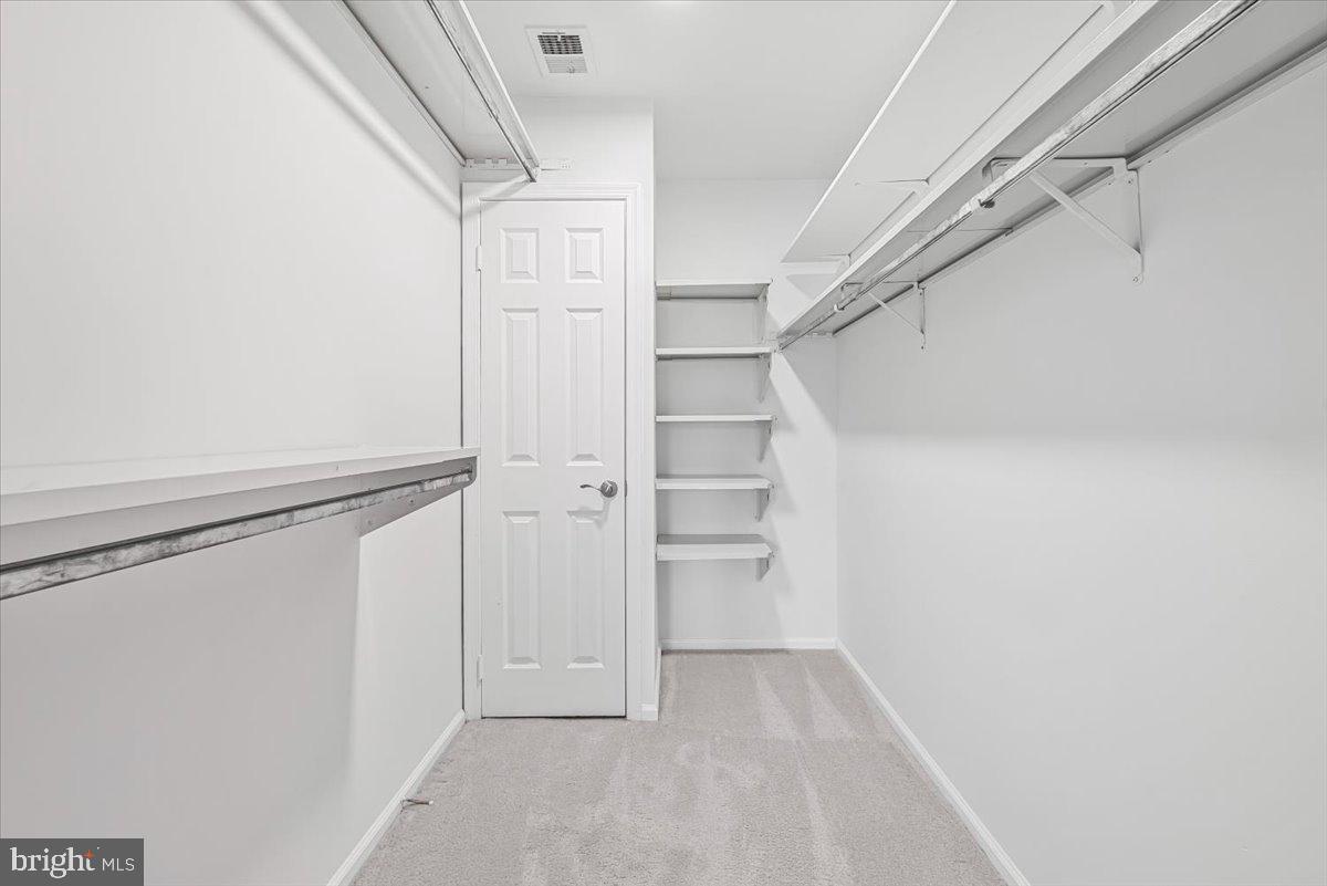 10717 Kings Riding Way, Unit 301 Rockville, MD 20852 - Photo 14 of 22 a view of walk in closet with empty racks