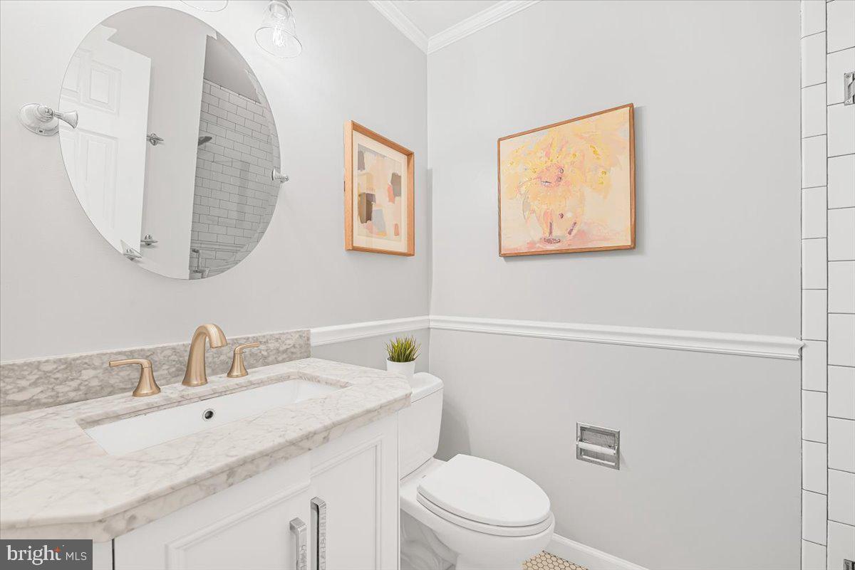 10717 Kings Riding Way, Unit 301 Rockville, MD 20852 - Photo 17 of 22 a bathroom with a toilet a sink and mirror