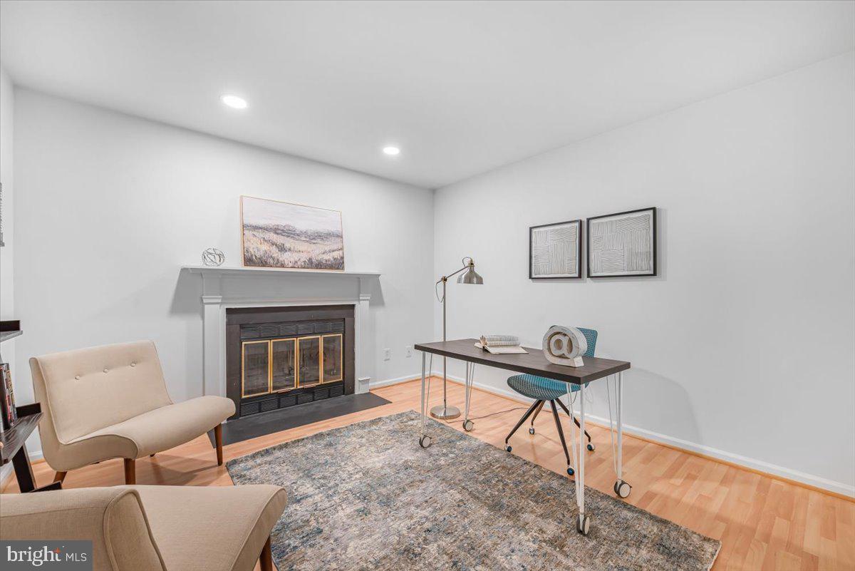10717 Kings Riding Way, Unit 301 Rockville, MD 20852 - Photo 8 of 22 a living room with furniture and a fireplace