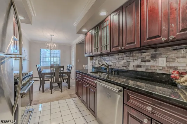 a kitchen with granite countertop a sink stove and cabinets